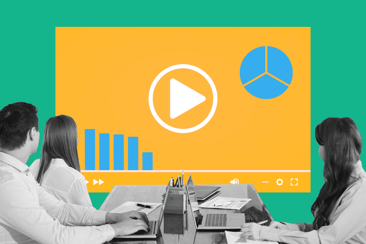 This image is of three people sitting around shared desks. They are all looking at a screen on the wall with video statistics. This image represents video marketing statistics.